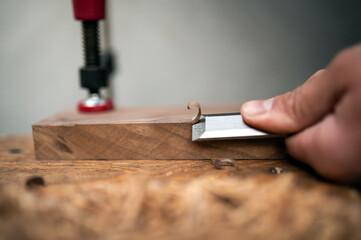 Close up shot of curled wood-shavings and chisel