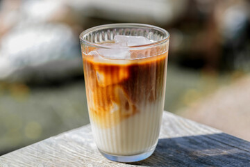 Ice coffee latte with oat milk isolated on bokeh background with day light.