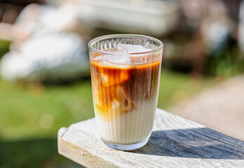 Ice coffee latte with oat milk isolated on bokeh background with day light.