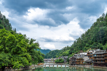 Naklejka premium Traditional Miao Architecture and Mountainous Scenery in Fenghuang Ancient Town, Hunan Xiangxi