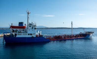 Industrial sea transportation, cargo ship moored at harbor Spetses island, Greece