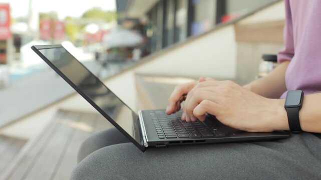 Close-up male hands typing on laptop keyboard. 