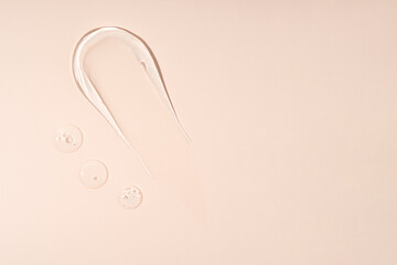 Smear of gel texture on beige background