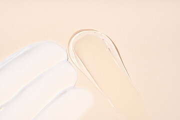 Smears of cream and gel textures on beige background