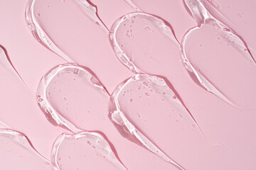 Texture of gel on pink background, smear and smudge gel