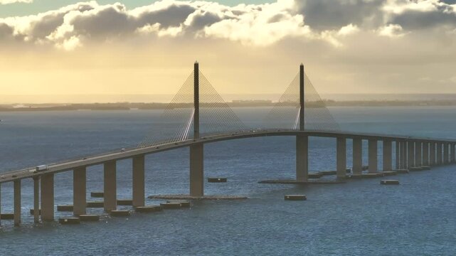 Aerial view of the skyway bridge over the tranquil waters of Tampa Bay at sunset, St Petersburg, United States.