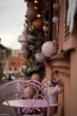 A small outdoor cafe table is set with simple decor, surrounded by charming decorations. 