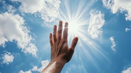 A hand reaching up towards the sky, with rays of sunlight breaking through the clouds