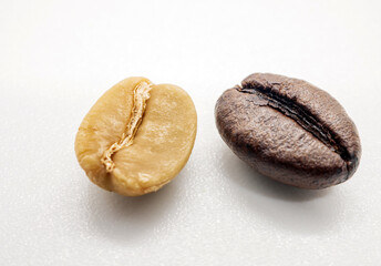 Close-up of green coffee bean seed and Coffee bean dark roasted seed on white background
