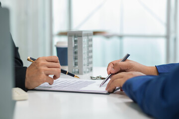 Real estate agent is talking to customer to present promotion for signing contract buy and selling...