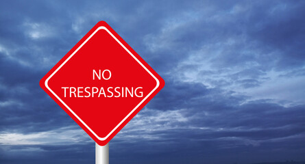 No trespassing sign on sky background