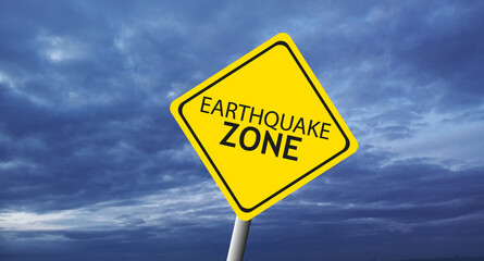 Caution Earthquake Zone Sign on Cracked Rock Background