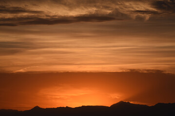 Fototapeta premium Panorama of mountains and cloudy sky at dusk