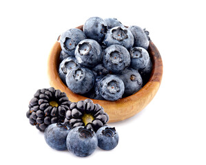 Blueberries Isolated on White Background. Ripe berries closeup in wooden bowl.  Berries with drops of water. Top view.