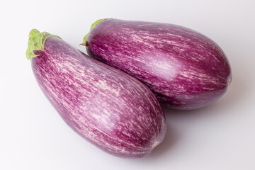 Striped eggplant on a white background, close-up.