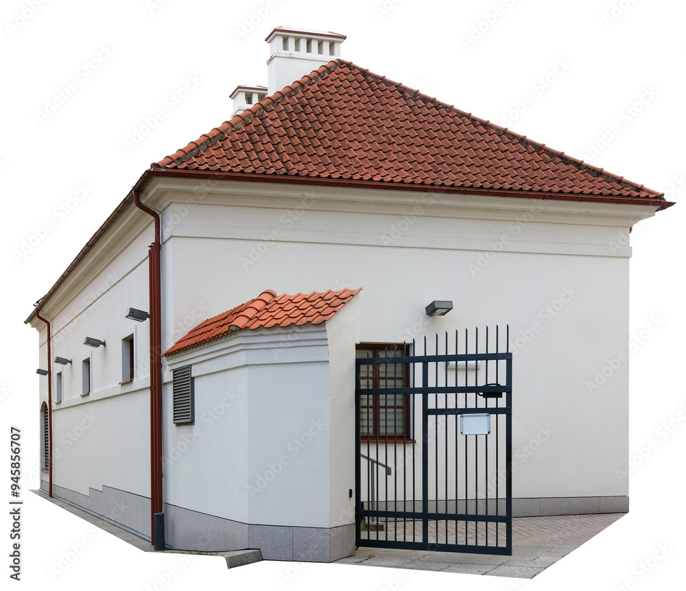 Wall mural ancient restored house with tiled red roof. and iron gates isolated