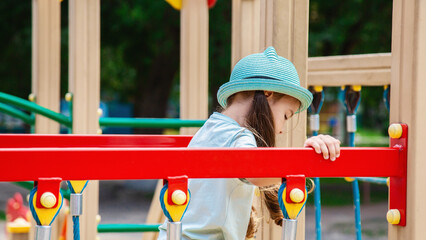 Cute preschool girl plays on a street playground. the concept of a healthy lifestyle. happy childhood.