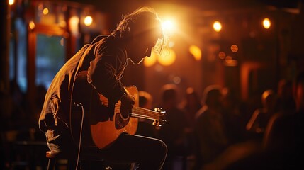 Silhouette of a musician playing guitar in a dimly lit venue during a live performance