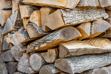 Background of stacked chopped wood logs. Pile of wood logs ready for winter. Wooden stumps,...