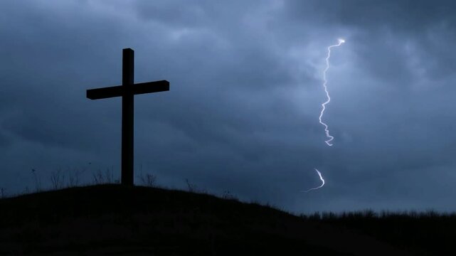 Cross silhouetted against a dramatic cloudy sky at dusk in a tranquil landscape