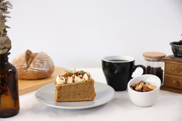 Tasty Caramel Nut Cake in white dish isolated on white background