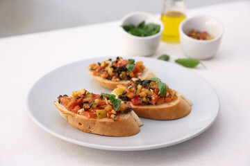 Bruschetta with Tomato and Basil Traditional toasted Italian food tomato bruschetta seasoned with spice and garnished with basil