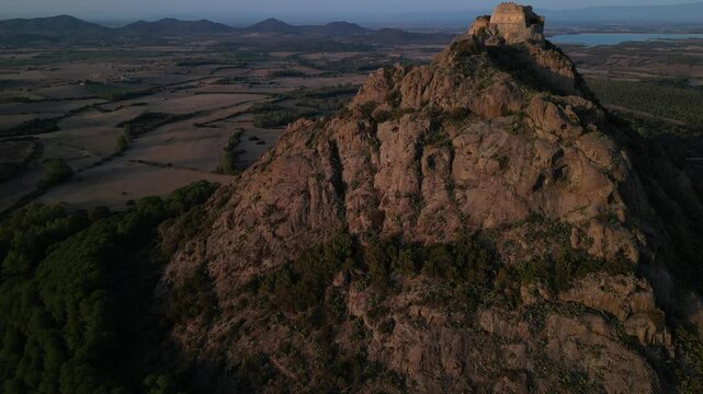 Castle located on a small mountain at sunset in Sardinia