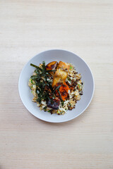 Miso barramundi with garlic fried rice and seaweed.
