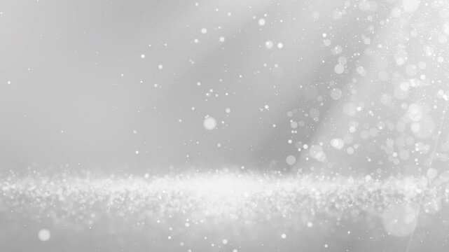 Glittering silver white particles create a mesmerizing wave on white background , perfect for elegant design projects.