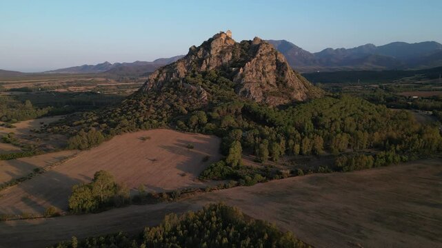 Castle located on a small mountain at sunset in Sardinia