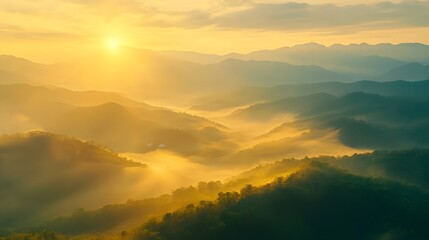 Obraz premium Serene Mountain Landscape at Sunrise Enveloped in Mist and Golden Light