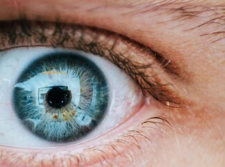 Close-up shot of a blue eye looking around, capturing the intricate details of the iris.