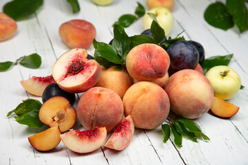 Peaches and apples on wooden background