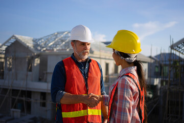 Blue collar workers are building house.