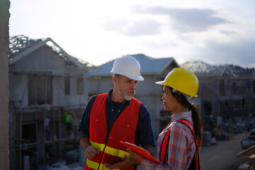 Blue collar workers are building house.