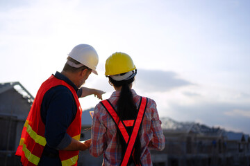 Blue collar workers are building house.