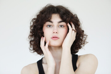 Close-up portrait of a young charming curly woman