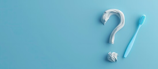 Naklejka premium A question mark formed by toothpaste and a toothbrush on a blue background representing the concept of choice. Copy space image. Place for adding text and design