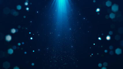 Abstract particles with glowing beams from above surrounded by bokeh on dark blue background.