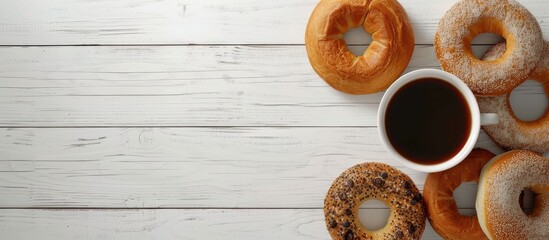 Different varieties of bagels and coffee Plain chocolate and spinach bagels A bright room featuring a white wooden table. Copy space image. Place for adding text and design