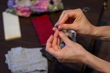 Shot of the woman with beautiful hands stitching. Craft