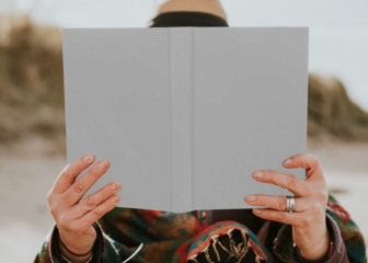 Book cover mockup png held by a senior woman outdoors