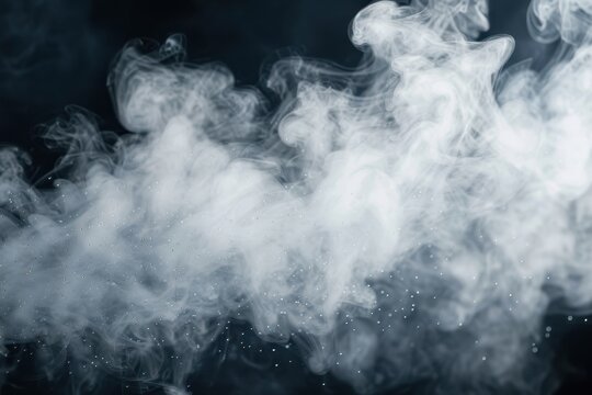 Close up of swirling white steam above water droplets isolated on black background