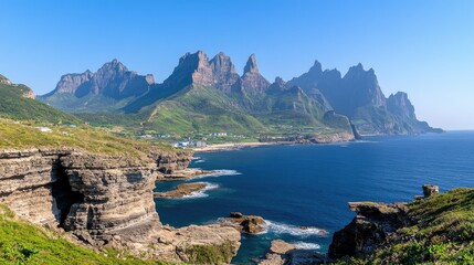 rocky coastline showcases vibrant textures against a backdrop of distant green peaks and a tranquil blue sea, creating a serene coastal atmosphere