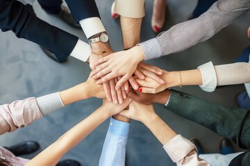 Business people hands in top view, connected, diverse, strong. Hands holding together in unity, teamwork, cooperation. Close-up of multi-ethnic group hands, fingers intertwined, success, support.