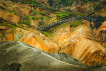Hiker alone on a trail in the impressive area of Landmannalaugar, deep in the Icelandic Highlands