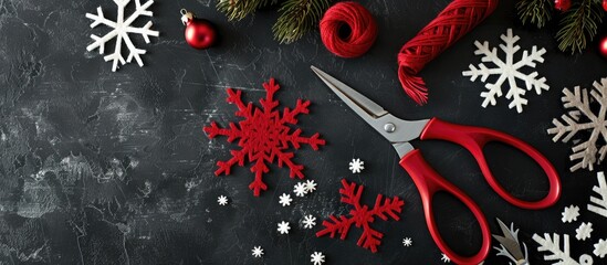 Creative DIY hobby Handmade tools for crafting contemporary Christmas gifts Top view of a black table featuring snowflakes felt craft supplies and scissors with copyspace