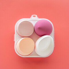 Cosmetic sponge for powder on pink background