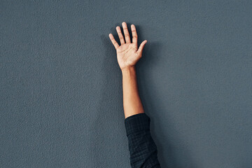 Wall background, reach and hand of person in studio raised for question, suggestion and answer. Mockup space, palm and isolated arm with signal or gesture for volunteering, asking and opinion