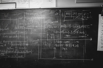 A chalkboard covered with mathematical equations in calculus.